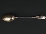a silver spoon and a silver spoon on a black surface