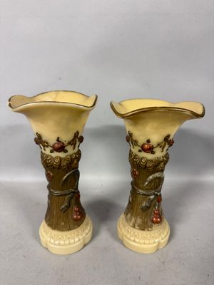 pair of antique vases with flowers and leaves on them