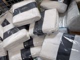 a pile of white blankets and blankets on display in a store