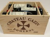 bottles of wine in a wooden crate on a white table