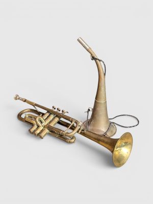 an image of a brass trumpet with a brass bell on a white background