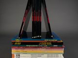 several books stacked on top of each other on a table
