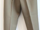 a person holding a pair of pants on a hanger