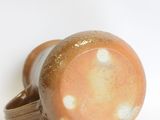 a close up of a ceramic object on a white surface