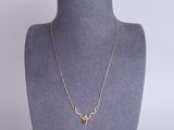 a gold necklace on a mannequin neck with a gold chain