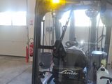 a red fork truck parked inside of a garage