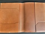 an image of a brown leather wallet sitting on top of a table