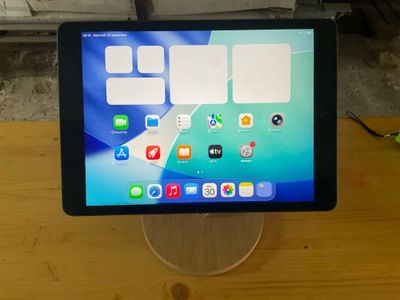 a tablet computer sitting on top of a wooden table