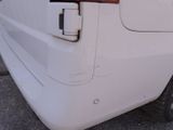 the rear end of a white van with the door open