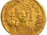 une pièce d'or sur laquelle est représentée une femme portant une coiffe
