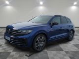 a blue volkswagen suv parked in a room with a checkered floor