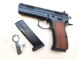 the gun is laying on the table next to the magazine