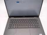 a laptop that is open on a white table