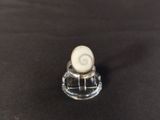 a close up of a small glass object on a table