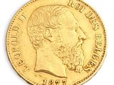 a close up of a gold coin with a man ' s face on it