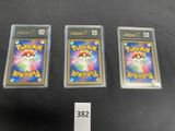 three pokemon trading cards sitting on top of a black table