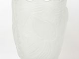 a white glass vase with a fish design on it