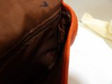 a brown bag with a brown handle and a brown bag with a brown handle and a brown bag with a brown handle and a brown bag with a white