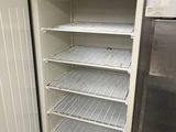 an empty refrigerator in a kitchen with a lot of shelves