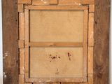 a close up of a picture frame on a table with a white wall behind it