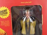 toy figure of a man in a yellow shirt and tie in a red box