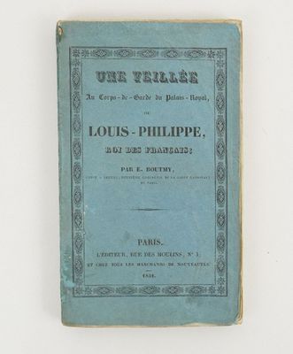 a blue book sitting on top of a table next to a white wall