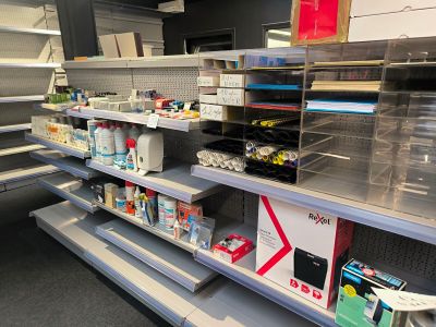 many empty shelves in a store with many items on them
