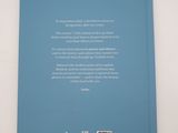 the back cover of a blue book on a white surface