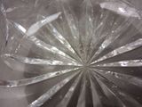 a close up of a clear plastic object with a starburst