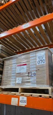 une grande pile de boîtes sur une palette dans un entrepôt
