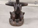 a statue of a man sitting on top of a table