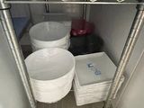 a metal shelf with plates and bowls on it
