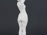 a white statue of a woman standing on a pedestal