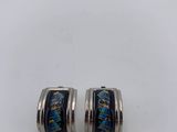 a pair of silver and blue glass earrings on a white surface