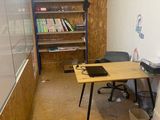 an image of a room with a desk and a book shelf
