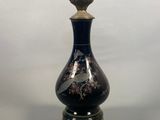 a black and gold lamp that is on a table