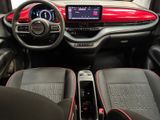 the interior of a red and black car with a steering wheel and dashboard
