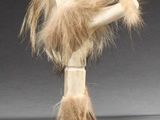 an image of a wooden doll with long hair