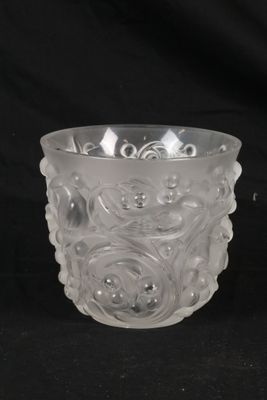 a clear glass cup with a flower design on it