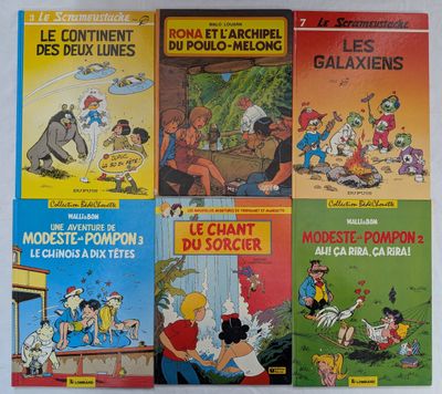 Plusieurs albums de BD sont alignés sur une surface blanche