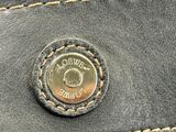 leather wallet with a coin on the inside of it