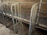 many metal beds lined up in a row in a room