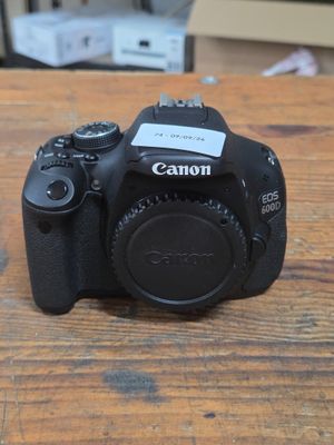 a canon camera sitting on a wooden table