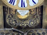 a clock that is sitting on a table with a key in it