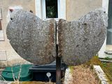 a stone sculpture of a bird sitting on top of a rock