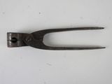 an old pair of pliers on a white surface