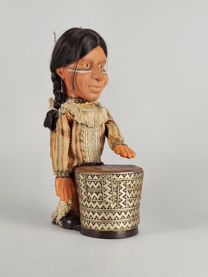 a small figurine of an indian woman with a drum