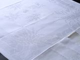 a close up of a white table cloth on a table