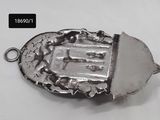a close up of a metal object on a white surface