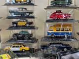 a lot of toy cars on display in a case